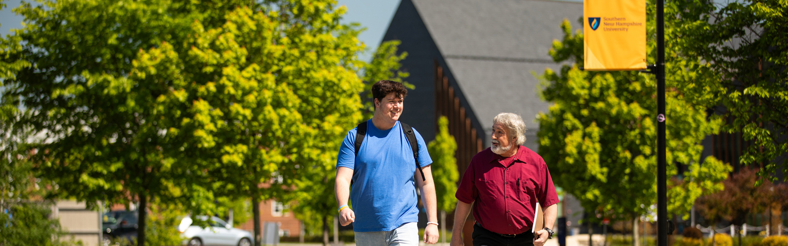 a man and a man walking on a sidewalk