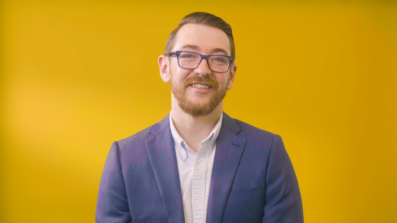 a man in a suit and glasses