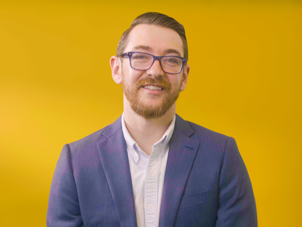 a man in a suit and glasses