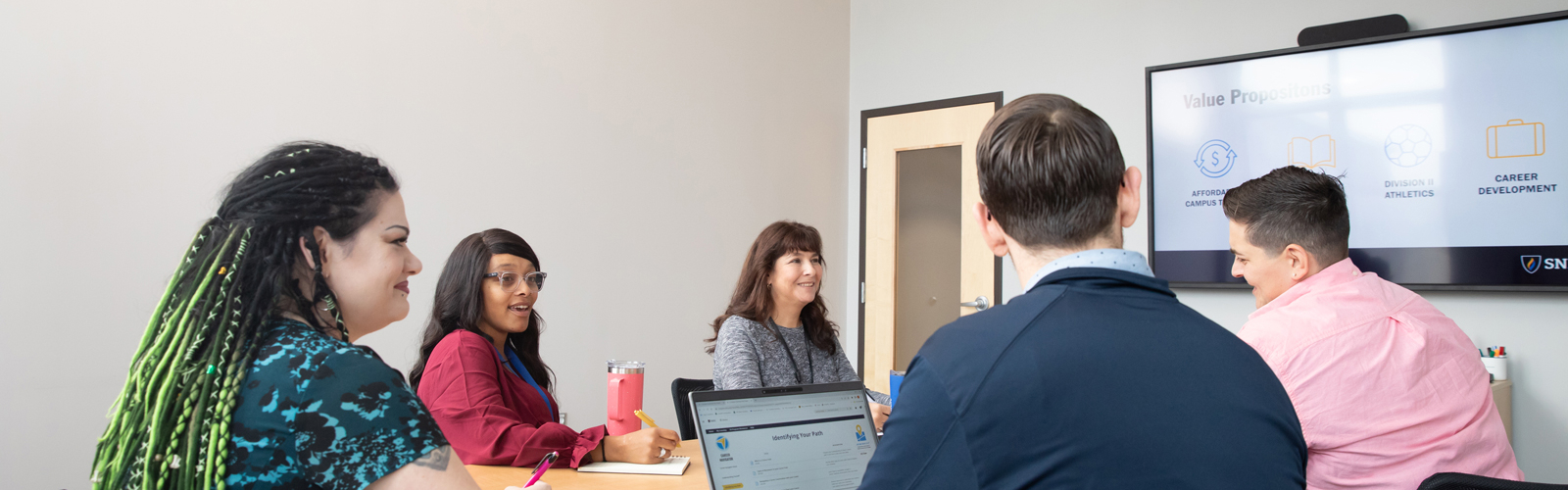 a group of people sitting around a table