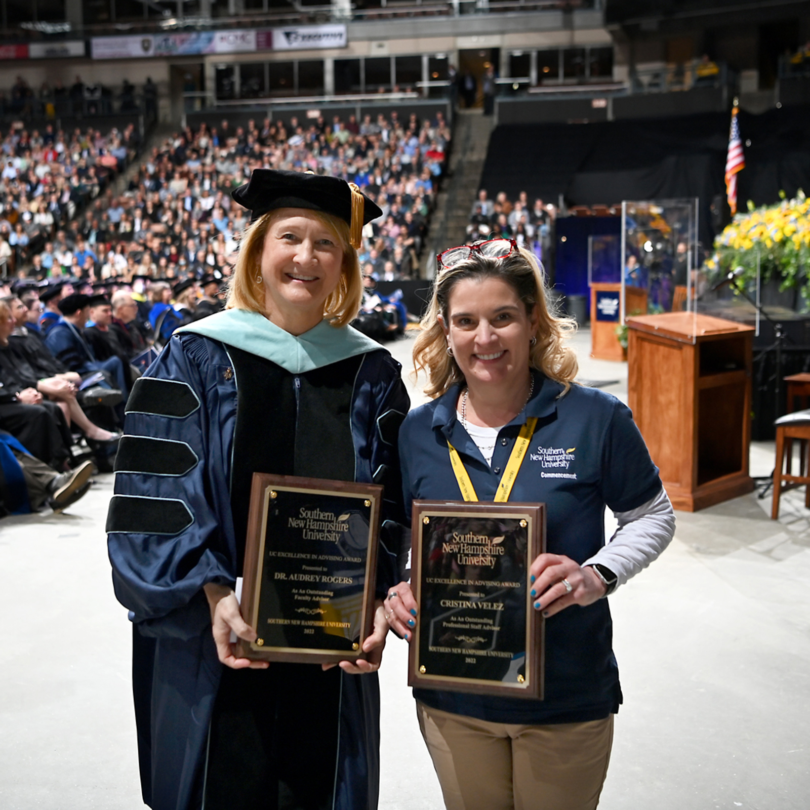 a couple of women holding plaques