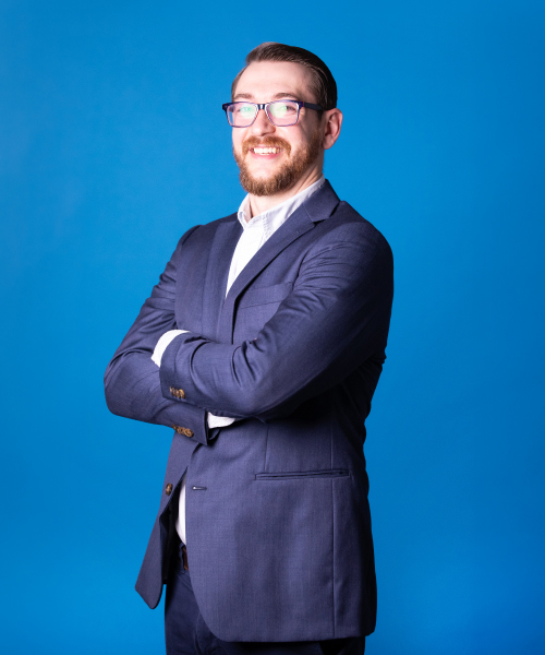 a man in a suit with his arms crossed