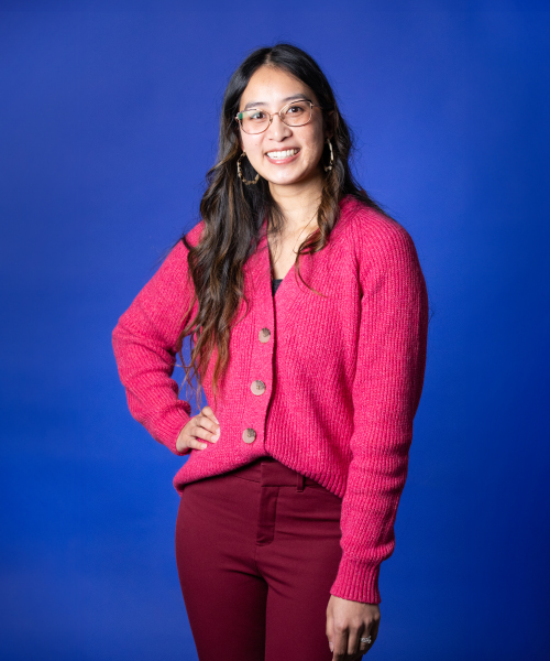a woman in a red sweater and glasses