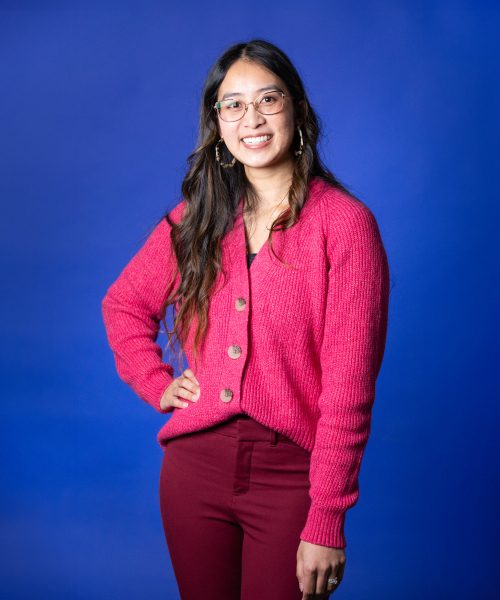 a woman in a red sweater and glasses