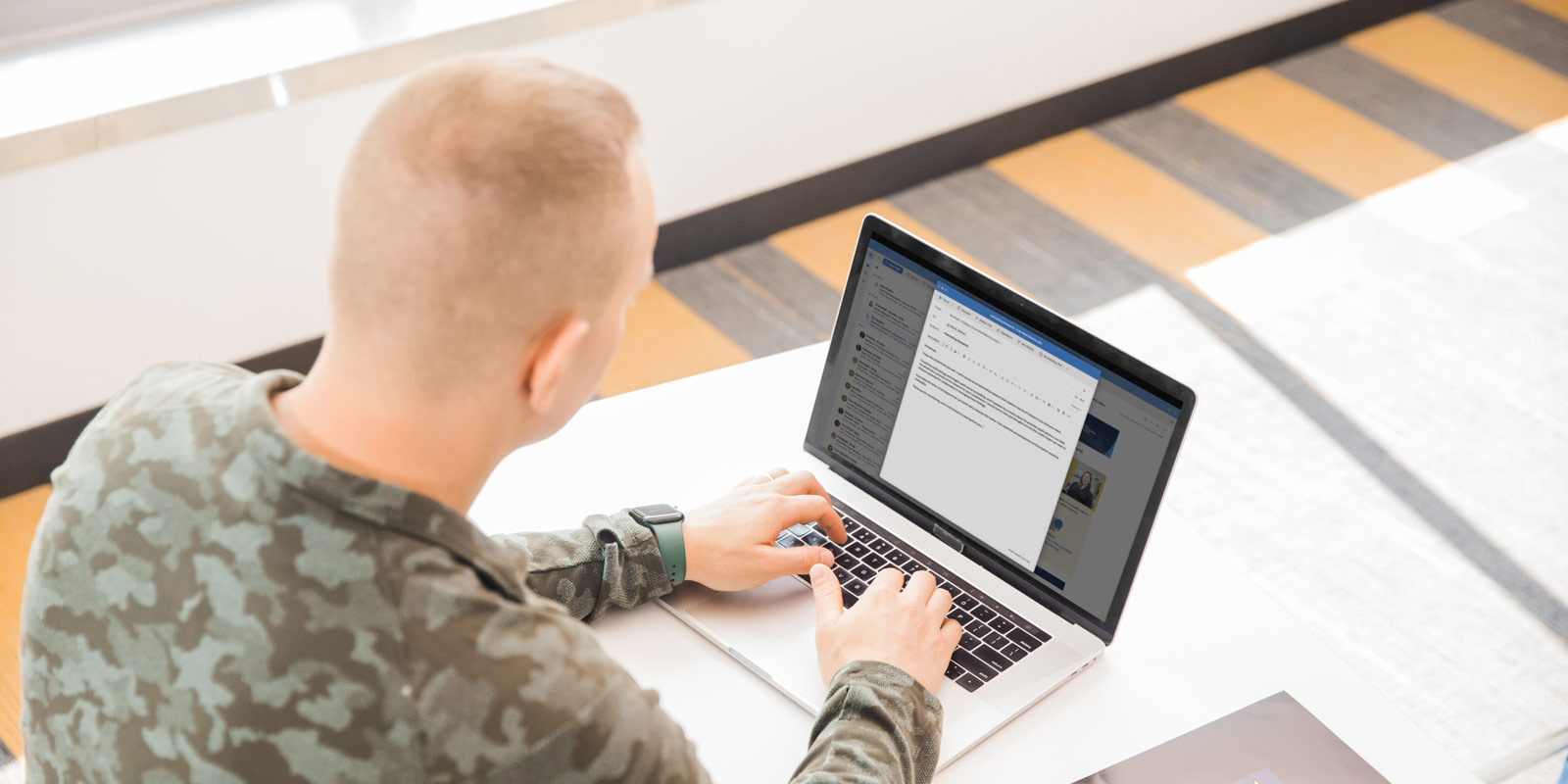 a man typing on a laptop