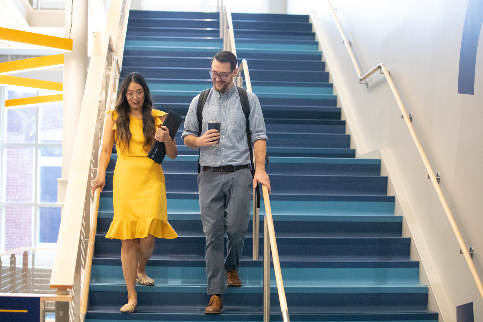 a man and woman walking up stairs