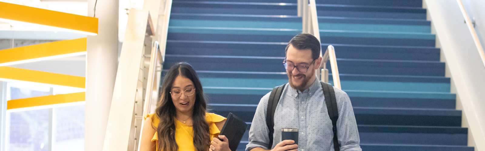 a man and woman walking up stairs