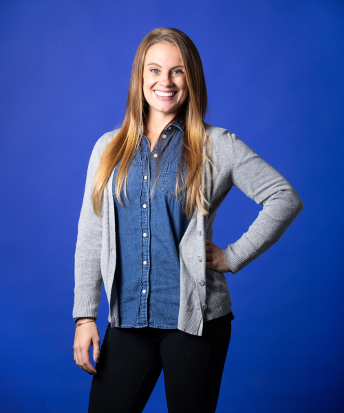 a woman smiling with her hand on her hip