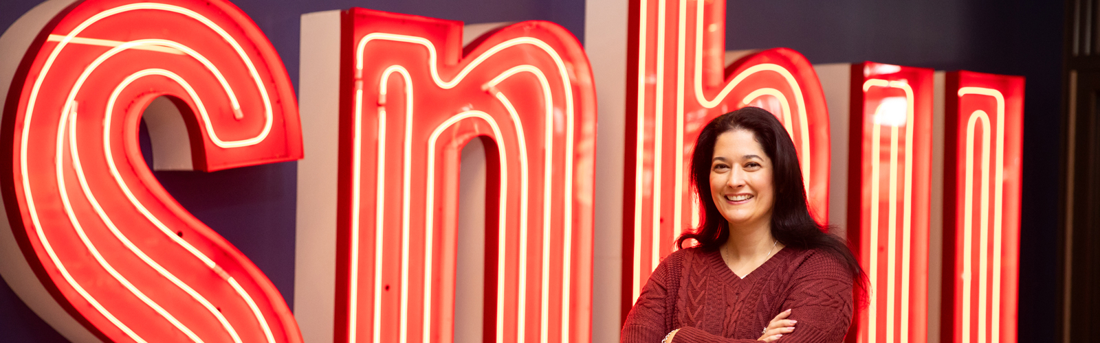 a woman standing in front of a sign