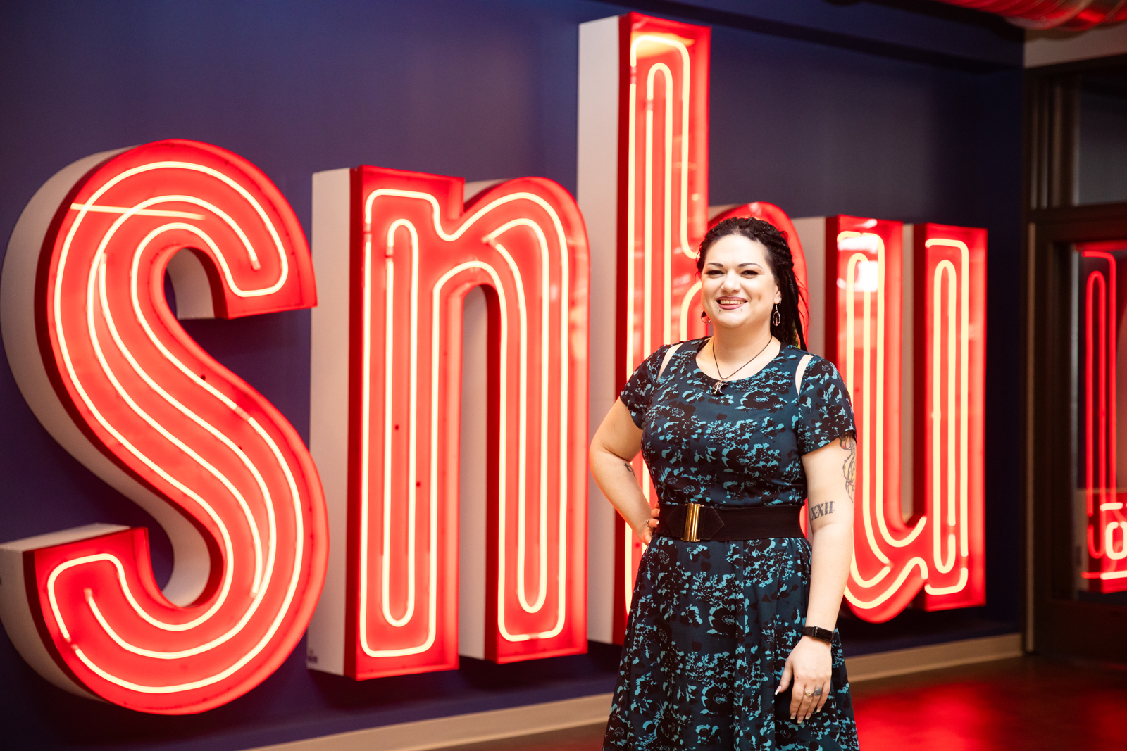 a woman standing in front of a sign