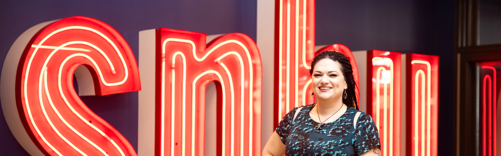 a woman standing in front of a sign