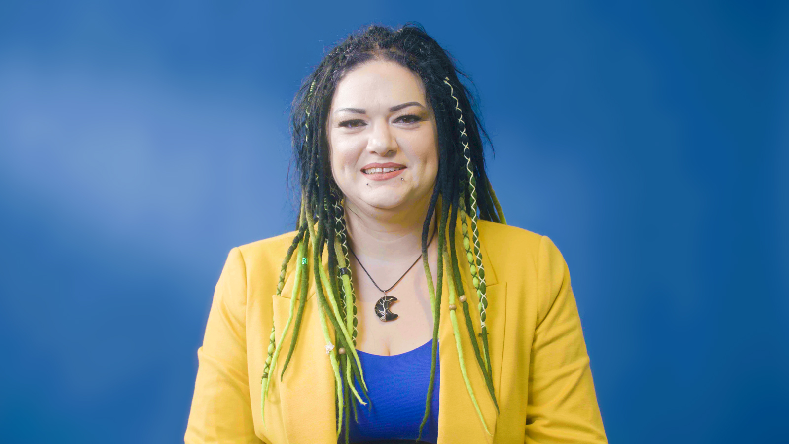 a woman with dreadlocks smiling
