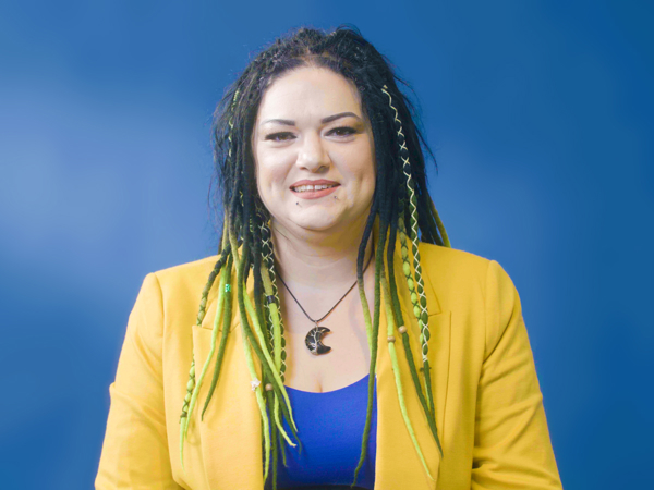 a woman with dreadlocks smiling