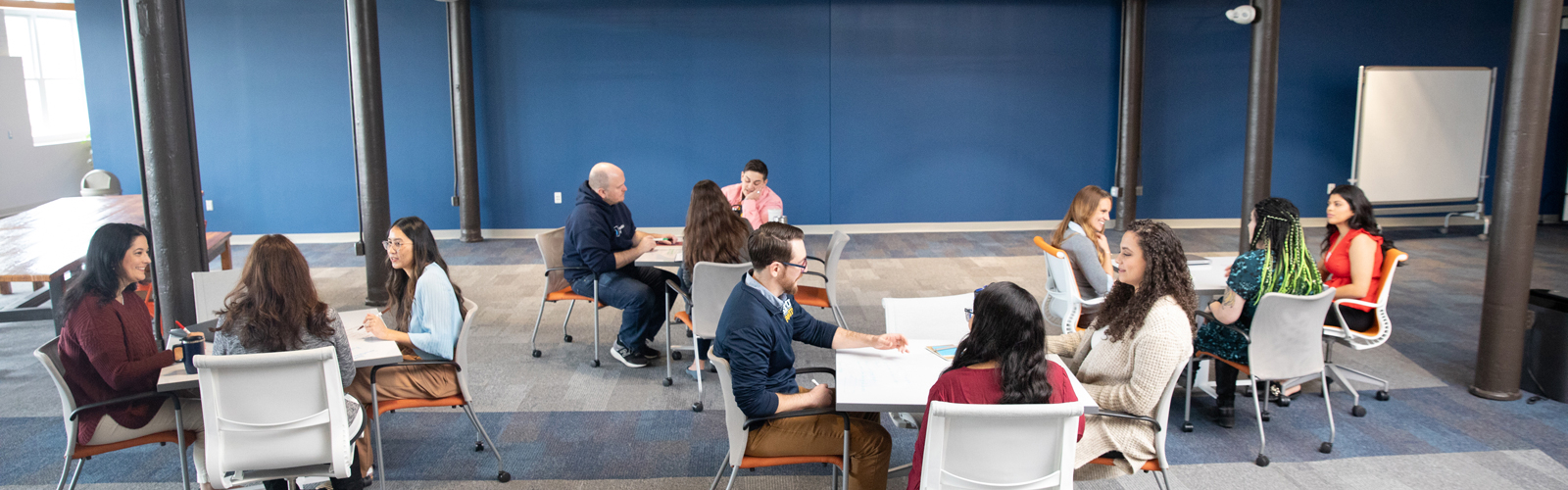 a group of people sitting at tables in a room