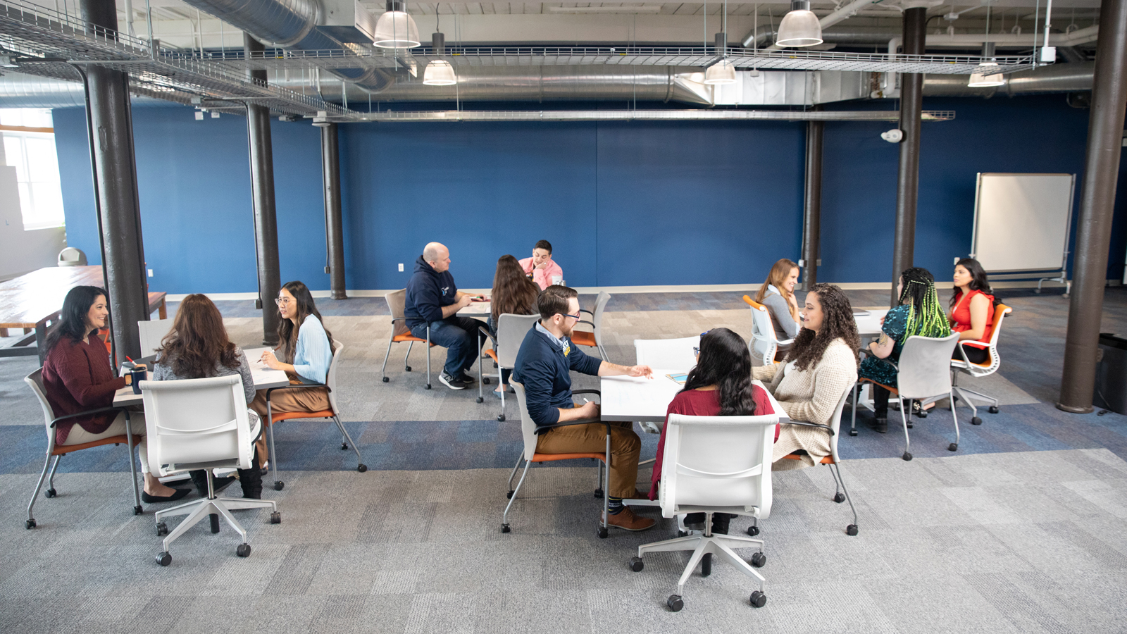 a group of people sitting at tables in a room