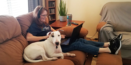 a woman sitting on a couch with a dog