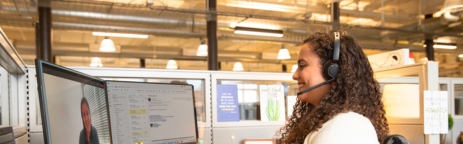 a woman wearing headphones and sitting at a desk