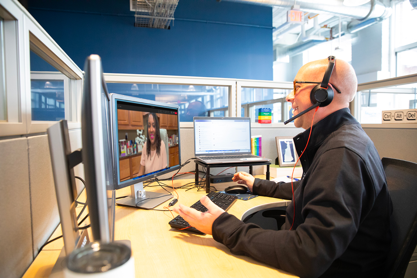 a man wearing headphones and talking on a computer