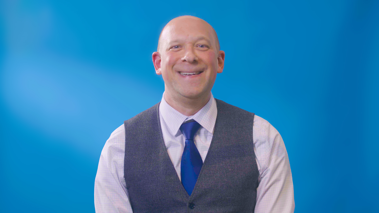 a man wearing a vest and tie