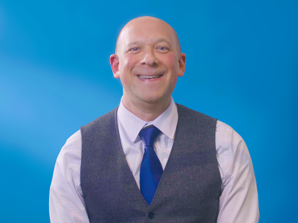 a man wearing a vest and tie