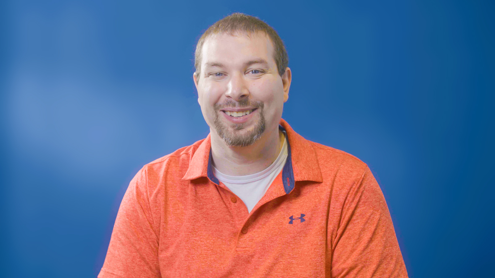 a man in an orange shirt